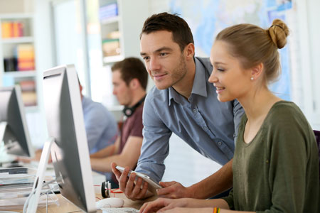 Student girl with trainer working on computer and tablet.